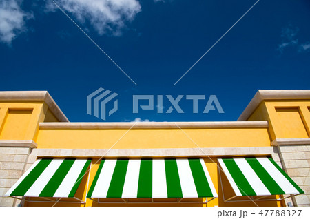 Green and white rooftop on blue sky Green and white rooftop on blue sky 47788327