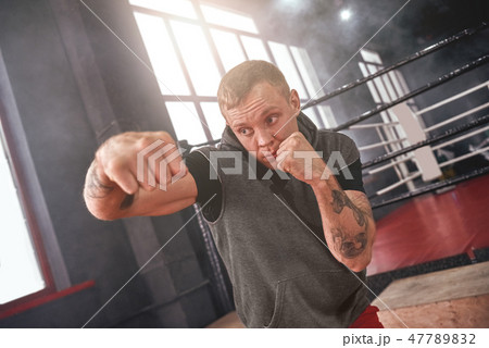 Power hook to the head. Close-up of confident handsome athlete in sports clothing throwing hook 47789832
