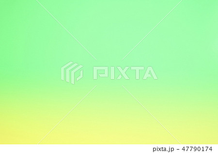 パステルカラー背景素材 黄色と黄緑色のグラデーションの写真素材