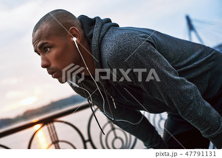 Tired because of running. Young jogger is stopped to catch his breath Tired because of running. Young jogger is stopped to catch his breath 47791131