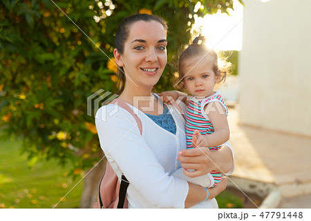 Mother hugging with her little daughter Mother hugging with her little daughter 47791448