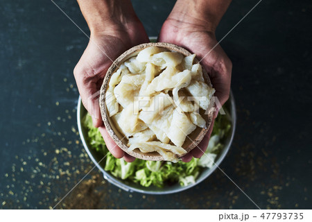 man preparing xato, catalan salad with raw cod 47793735