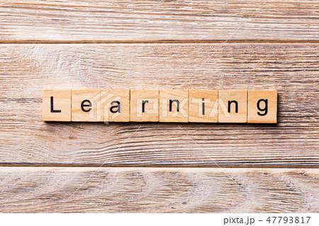 LEARNING word written on wood block. 47793817