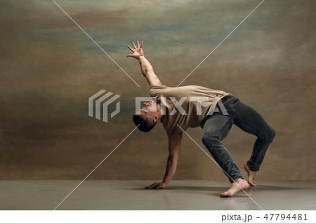 The young man dancing on gray 47794481