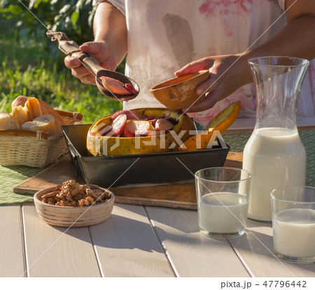 baked fruit and berries in a pumpkin 47796442
