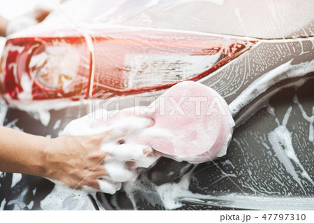 The man hand with pink sponge clean washing car  47797310