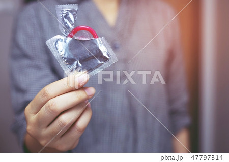 Condom ready to use in man hand, give condom Condom ready to use in man hand, give condom 47797314