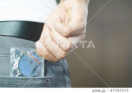 Condom man ready to use in Jeans pocket Condom man ready to use in Jeans pocket 47797573