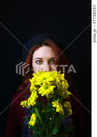 Woman holds a yellow chrysanthemum 47798297