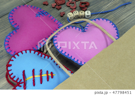 Bag full of handmade heart souvenir on rustic wood 47798451
