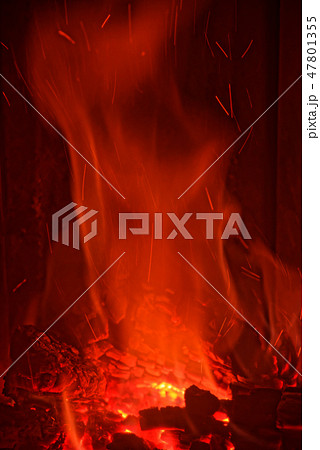 Red flames from burning wood in a fireplace Red flames from burning wood in a fireplace 47801355