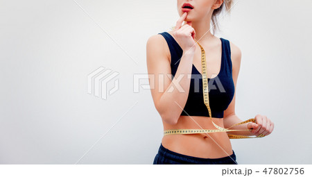 beautiful adult sport girl holding measure tape beautiful adult sport girl holding measure tape 47802756