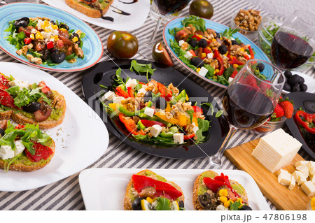 Vegetarian salads and sandwiches on dining table Vegetarian salads and sandwiches on dining table 47806198