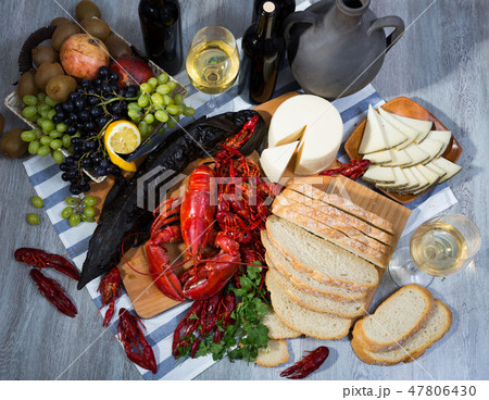 Top view of smoked sturgeon, crustaceans, fruits and wine Top view of smoked sturgeon, crustaceans, fruits and wine 47806430