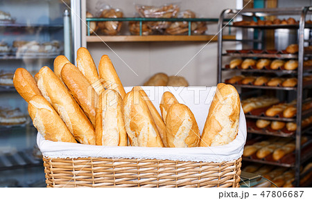 Baked baguettes in wicker basket Baked baguettes in wicker basket 47806687