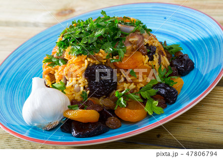 Lamb pilau with dried fruits and greens Lamb pilau with dried fruits and greens 47806794