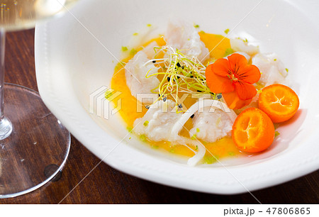 Seafood ceviche from horse-mackerel with spicy avocado sauce, greens and cumquat 47806865