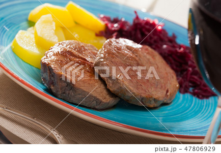 Beef steaks with potatoes and pickled cabbage 47806929