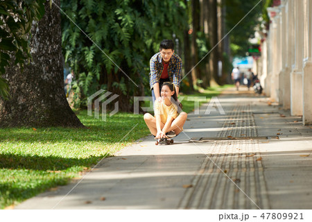 Couple riding on skateboard Couple riding on skateboard 47809921