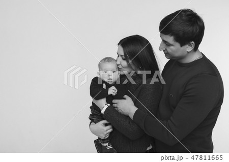baby on the hands of parents on a white background. 47811665