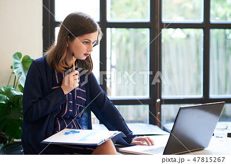 Serious business lady working on report 47815267