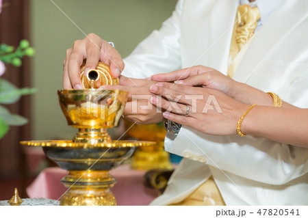Pouring water into the cup for a fortune Pouring water into the cup for a fortune 47820541