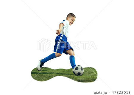 Young boy kicks the soccer ball 47822013