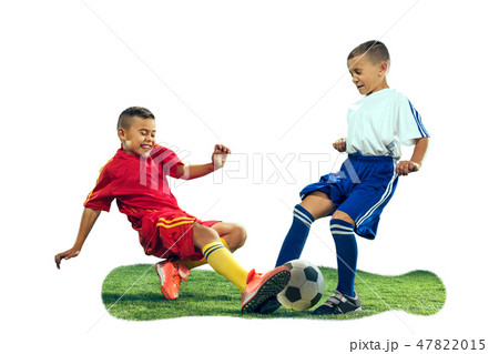 Young boys kicks the soccer ball Young boys kicks the soccer ball 47822015