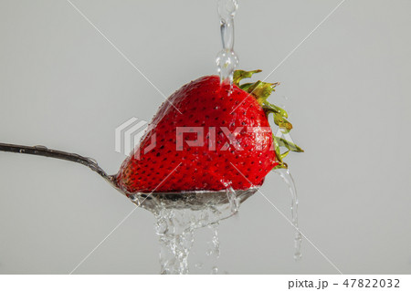 Washing a Strawberry Washing a Strawberry 47822032