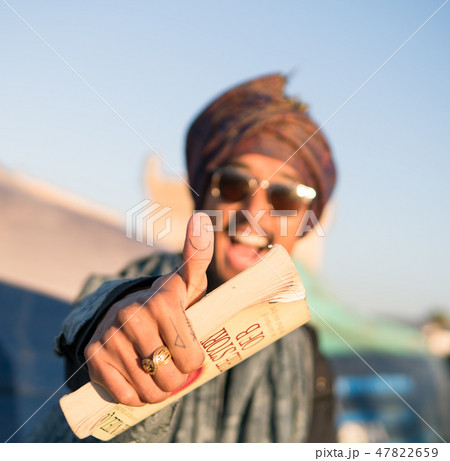 Young Asian Bearded Tourist man with Book Having Fun in Essaouira, Morocco at the evening sunset Young Asian Bearded Tourist man with Book Having Fun in Essaouira, Morocco at the evening sunset 47822659