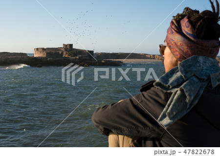 Young Asian Bearded Tourist man with Dreadlocks and scarf on head Walking on the Ocean Coast in Young Asian Bearded Tourist man with Dreadlocks and scarf on head Walking on the Ocean Coast in 47822678