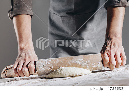 Chef making and kneading fresh dough 47826324