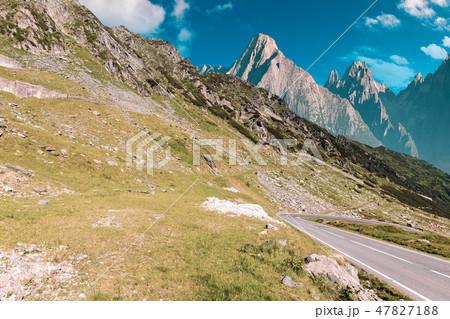 road through mountains with rocky cliff road through mountains with rocky cliff 47827188