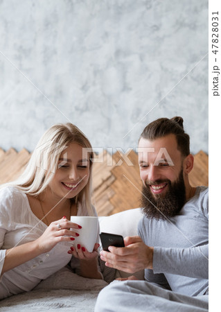 young couple anniversary planning check smartphone young couple anniversary planning check smartphone 47828031