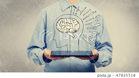 Brain illustration with man holding a tablet 47835518