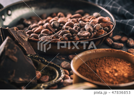 Dark chokolate cocoa beans and powder on concrete table 47836853