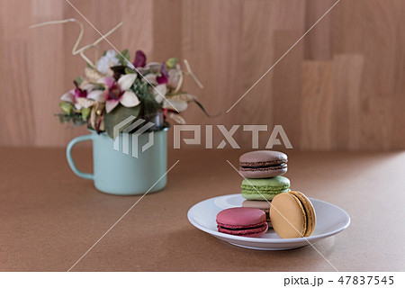 French sweet delicacy macaroons and flower vase  47837545