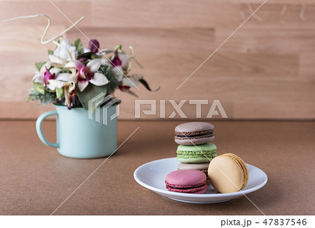 French sweet delicacy macaroons and flower vase 47837546