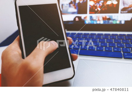 Man holding mobile with blank screen in office 47840811