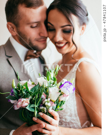 Bride and groom embrace 47841107