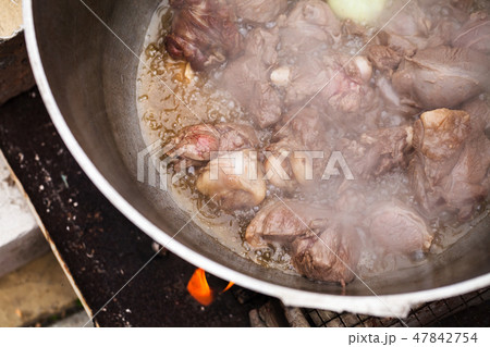 Lamb with onion boiling in a cauldron 47842754