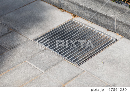 Manhole cover metal in a city street 47844280