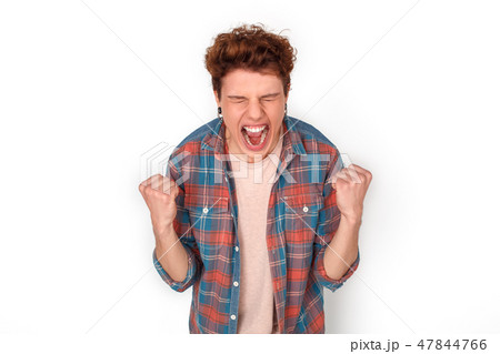 Teenager with earrings studio standing isolated on white hands in fist shouting happy close-up Teenager with earrings studio standing isolated on white hands in fist shouting happy close-up 47844766