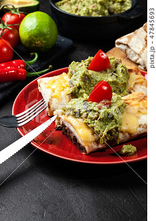 Mexican chimichanga with guacamole dip 47845693