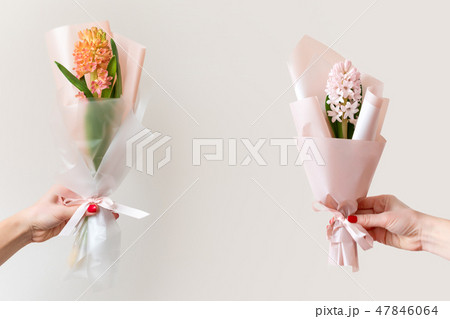 Woman hands with manicure holding spring flowers. Fresh bouquets with hyacinth. Copyspace for text 47846064