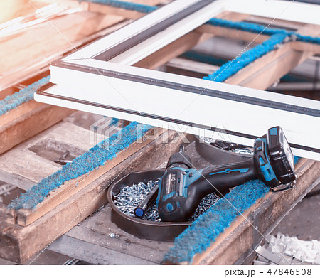 Production of pvc windows, screwdriver lies near the pvc frame, manufacturing of plastic windows 47846508