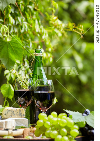 Old wooden barrel with bottle and glass 47849010