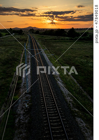 Railway tracks from above at sunset behind clouds 47849018