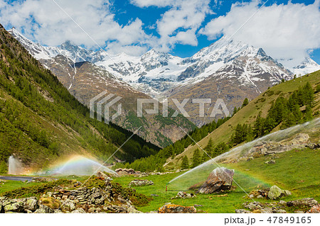 Rainbows in irrigation water spouts, Alps mountain Rainbows in irrigation water spouts, Alps mountain 47849165