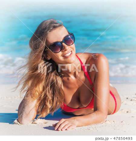 Woman laying by tropical sea Woman laying by tropical sea 47850493